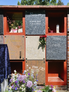 Installed columbarium plaque at Heidefriedhof, surrounded by other memorial plates